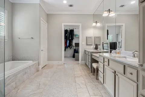 a bathroom with a sink a toilet a mirror and shower