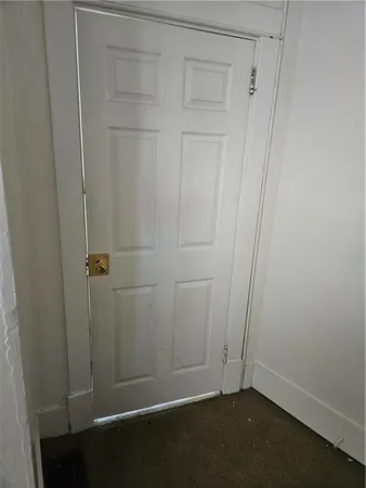 an empty room with a wooden door