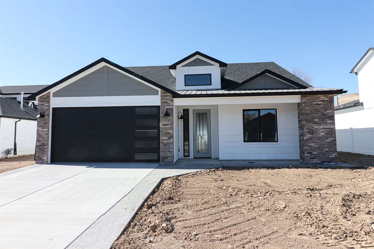 810 Rupp Avenue Palisade, CO 81526 - Photo 1 of 27 a front view of a house with a yard and garage