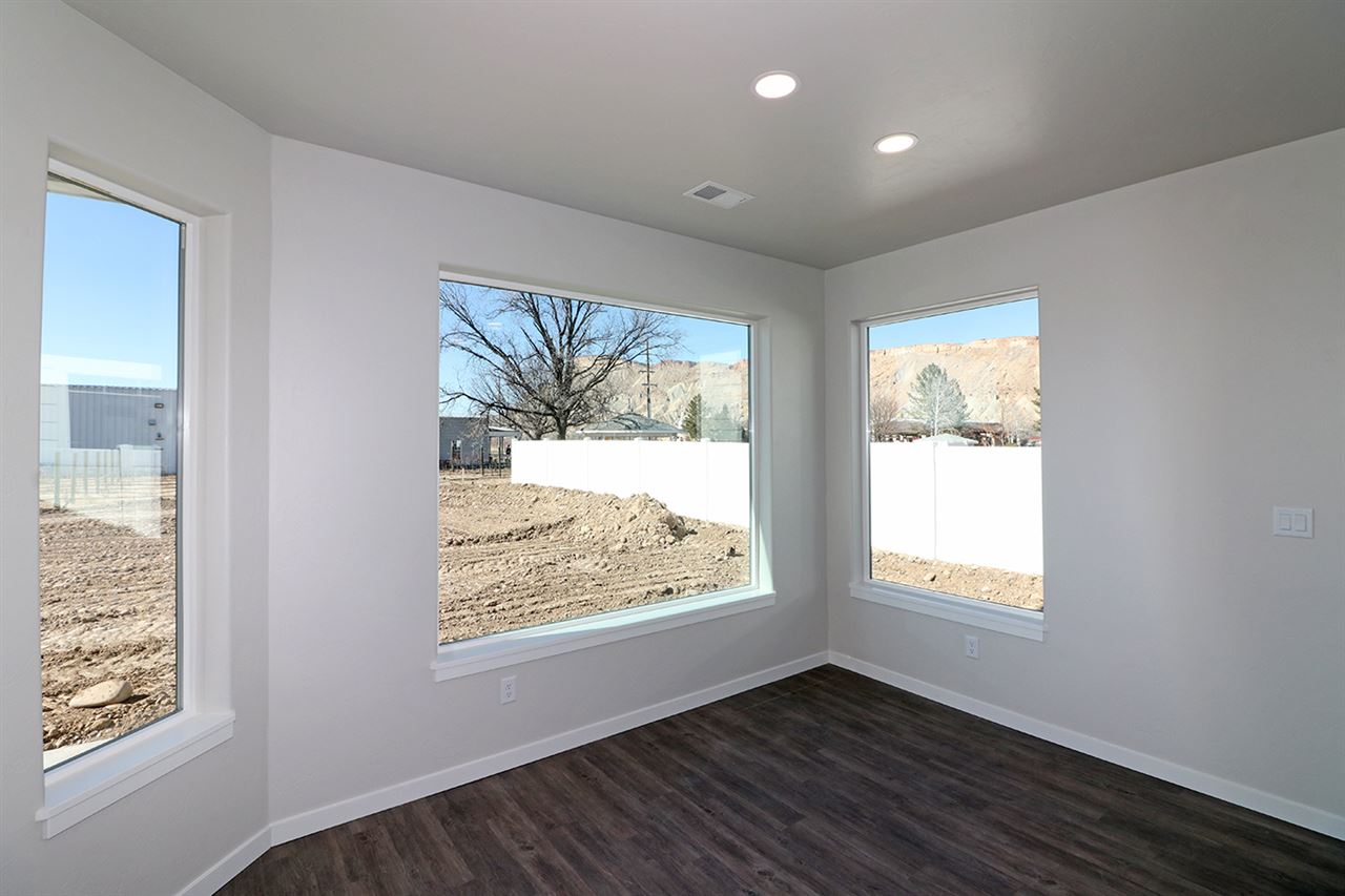 810 Rupp Avenue Palisade, CO 81526 - Photo 11 of 27 a view of an empty room with wooden floor and a window