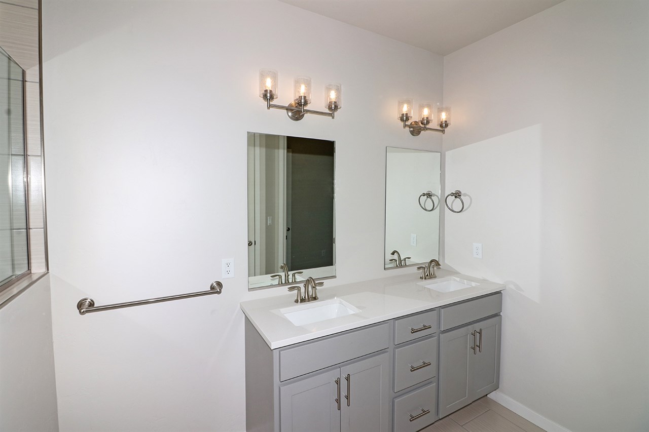 810 Rupp Avenue Palisade, CO 81526 - Photo 17 of 27 a bathroom with a double vanity sink and a mirror