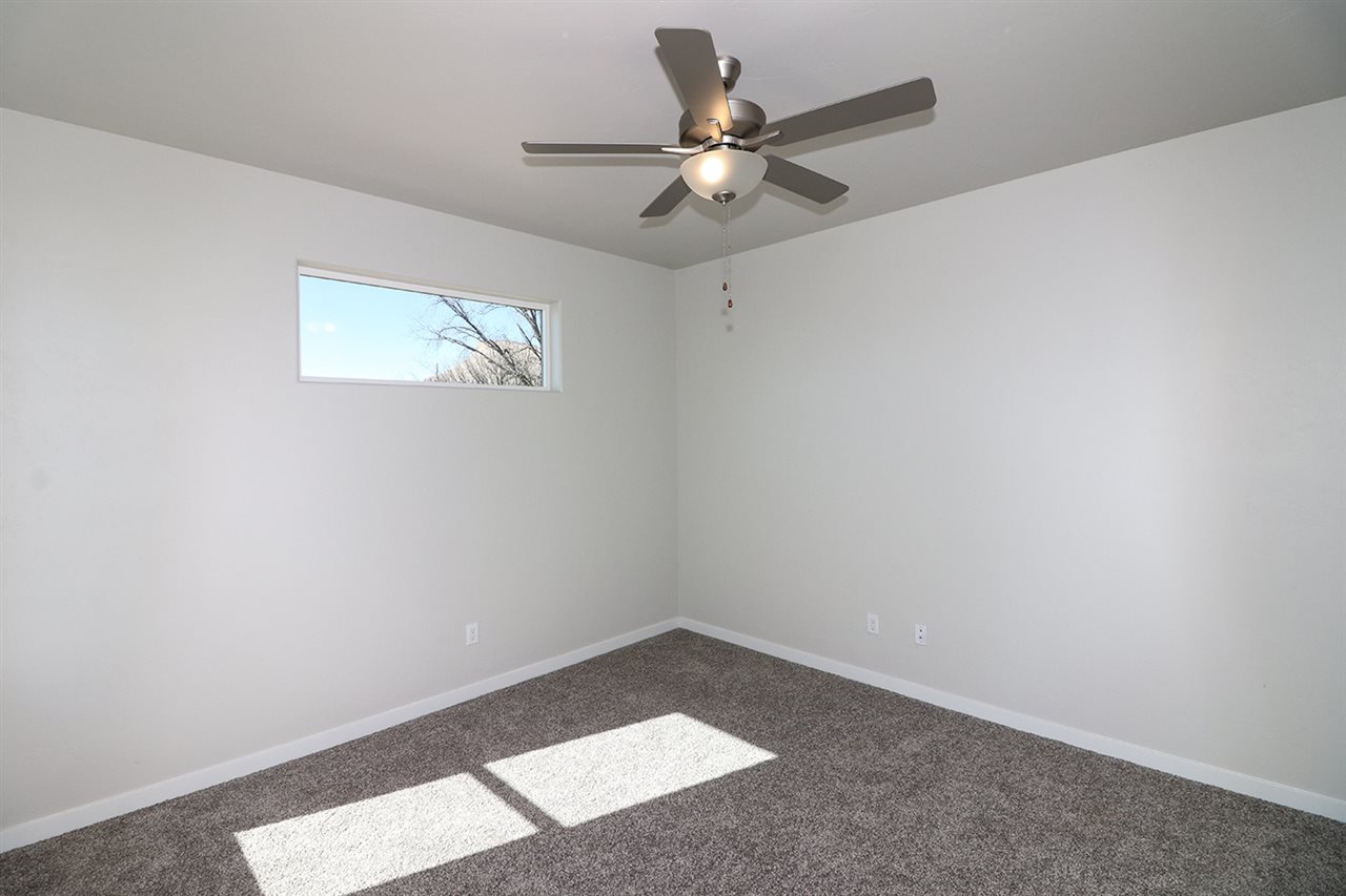 810 Rupp Avenue Palisade, CO 81526 - Photo 22 of 27 an empty room with a window and a fan