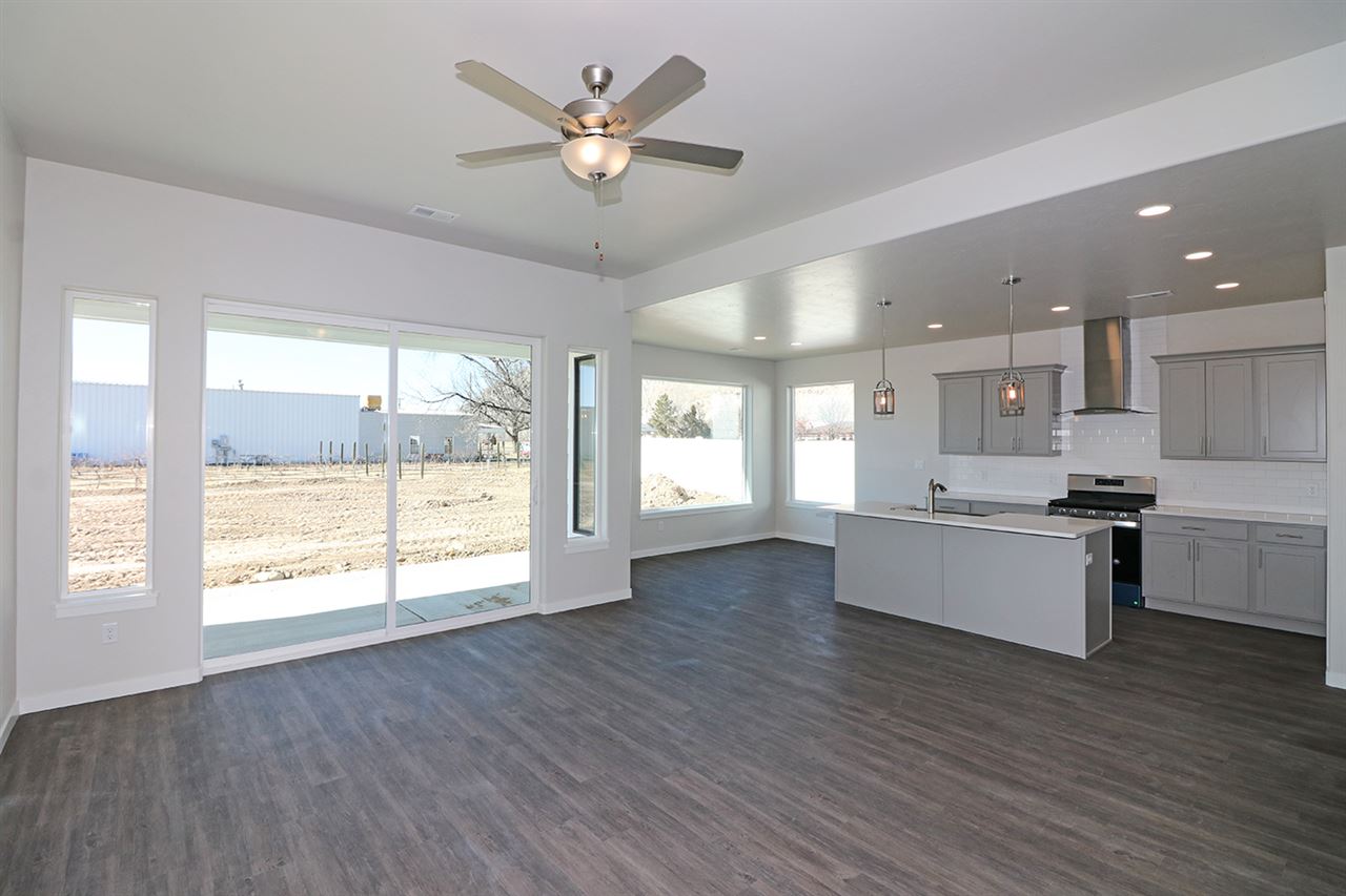 810 Rupp Avenue Palisade, CO 81526 - Photo 5 of 27 a large kitchen with stainless steel appliances granite countertop a large window a sink and a stove