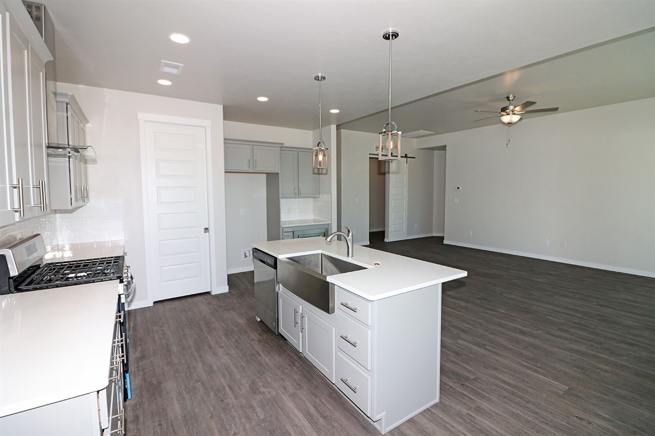 810 Rupp Avenue Palisade, CO 81526 - Photo 7 of 27 a kitchen that has a sink a stove and a wooden floor