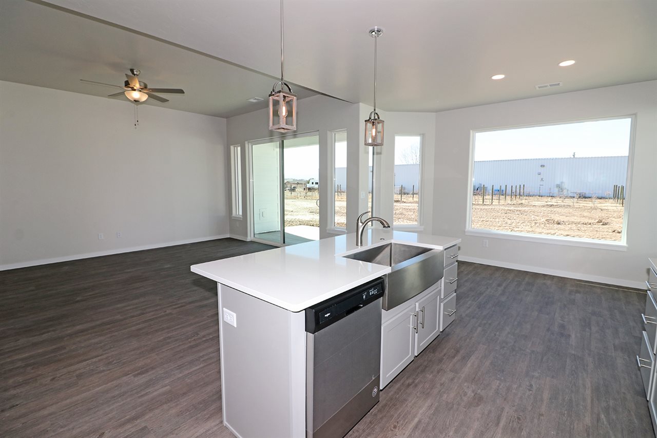 810 Rupp Avenue Palisade, CO 81526 - Photo 8 of 27 a kitchen with kitchen island wooden floor center island and stainless steel appliances