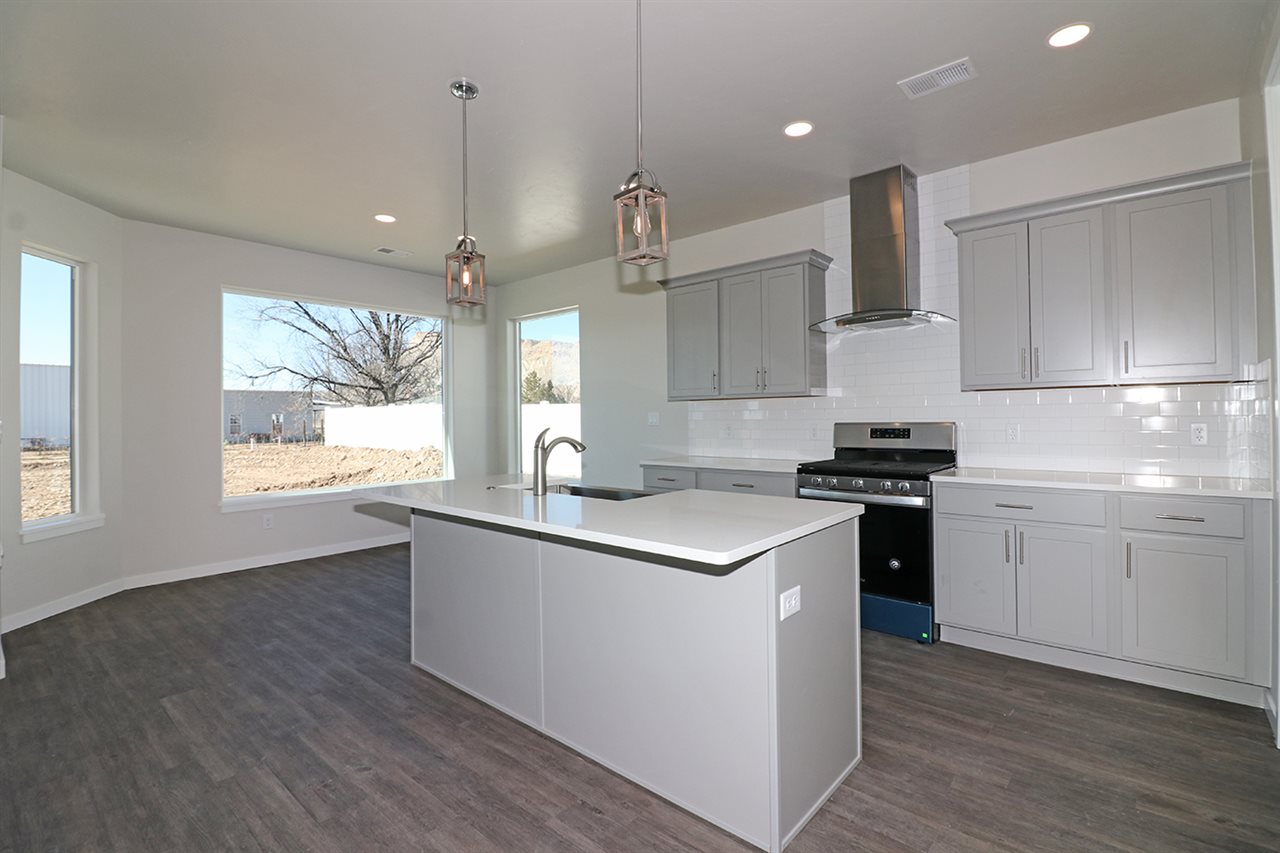 810 Rupp Avenue Palisade, CO 81526 - Photo 9 of 27 a kitchen with stainless steel appliances granite countertop a sink a stove and a refrigerator