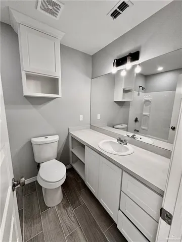 a bathroom with a sink toilet and mirror