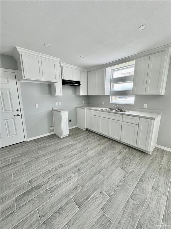 436 East Acacia Avenue, Unit 4 Alamo, TX 78516 - Photo 2 of 15 a kitchen with cabinets wooden floor and a window