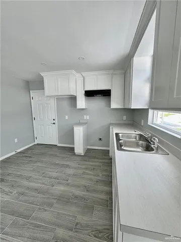 a kitchen with a stove and a white cabinets