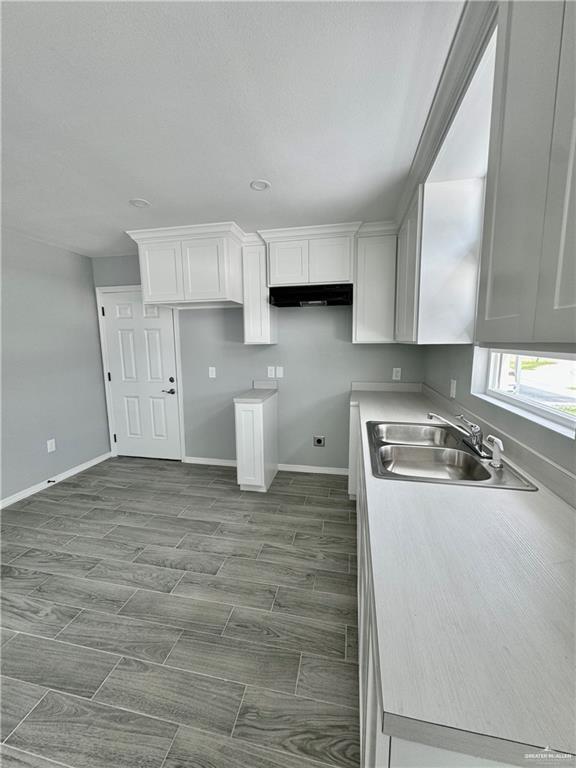 436 East Acacia Avenue, Unit 4 Alamo, TX 78516 - Photo 3 of 15 a kitchen with a stove and a white cabinets