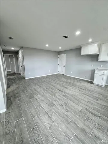 a view of a livingroom with kitchen and furniture