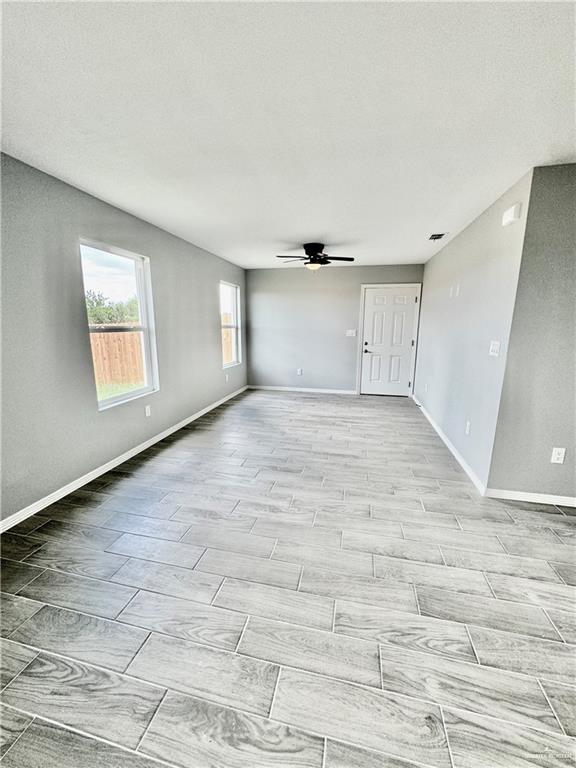 436 East Acacia Avenue, Unit 4 Alamo, TX 78516 - Photo 6 of 15 a view of empty room with wooden floor and fan