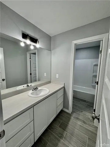 a bathroom with a double vanity sink and mirror