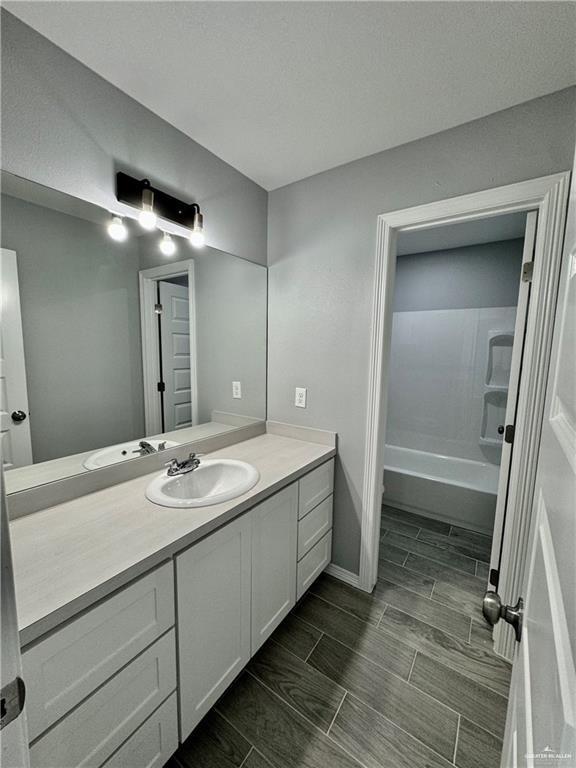 436 East Acacia Avenue, Unit 4 Alamo, TX 78516 - Photo 7 of 15 a bathroom with a double vanity sink and mirror