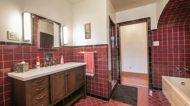 a bathroom with a sink a toilet and mirror
