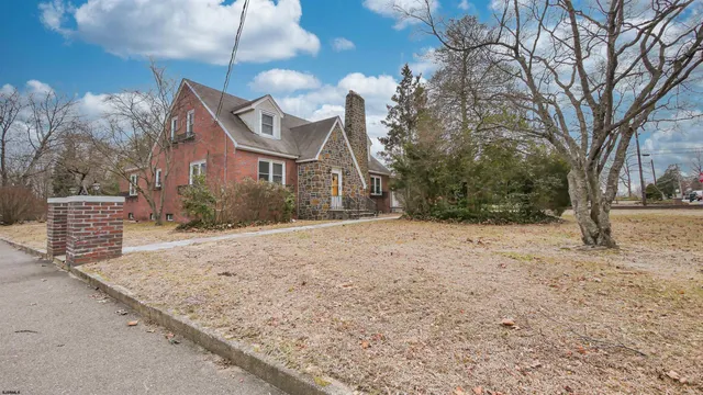 a view of a house with a yard and garage