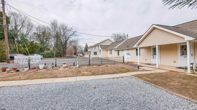 a front view of a house with a yard covered in snow