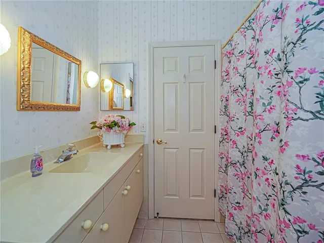 a bathroom with a sink mirror and vanity