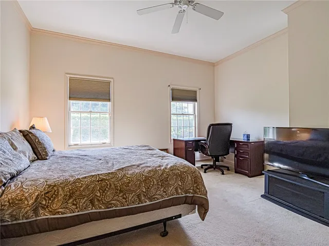 a bedroom with a bed and a television