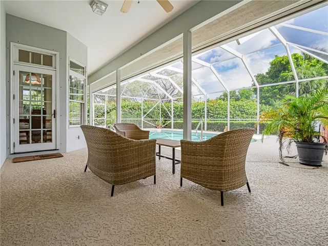 a view of a house with backyard porch and sitting area