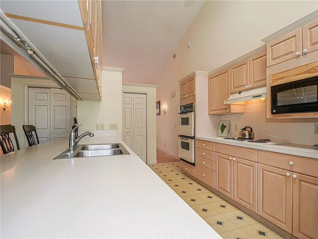 a kitchen with sink cabinets and appliances