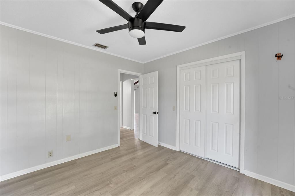404 Lake Ned Road Winter Haven, FL 33884 - Photo 14 of 18 an empty room with wooden floor and windows