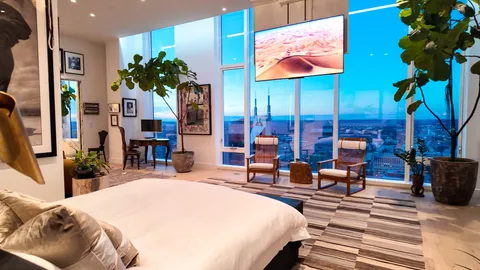 a bedroom with bed and a potted plant