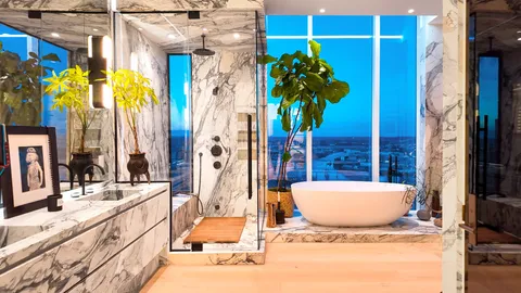 a bathroom with a tub sink and mirror