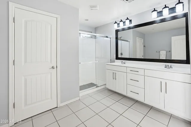 a bathroom with a sink vanity and mirror