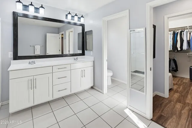 a bathroom with a sink a toilet and a mirror