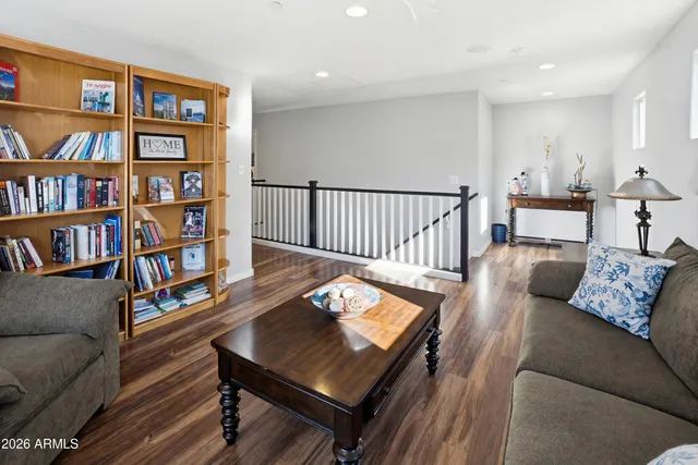 a living room with furniture a rug and a book shelf