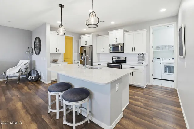a kitchen with stainless steel appliances kitchen island granite countertop a sink and cabinets