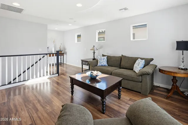a living room with furniture and a wooden floor