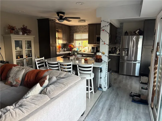 a view of a dining room with furniture a kitchen and chandelier