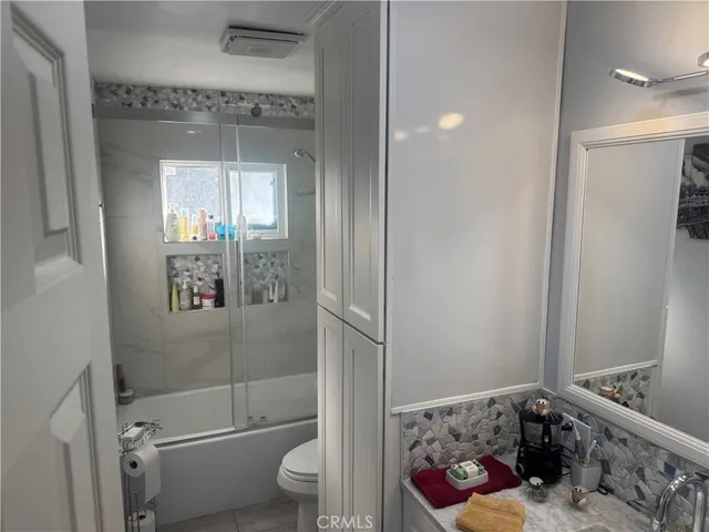 a bathroom with a toilet and shower