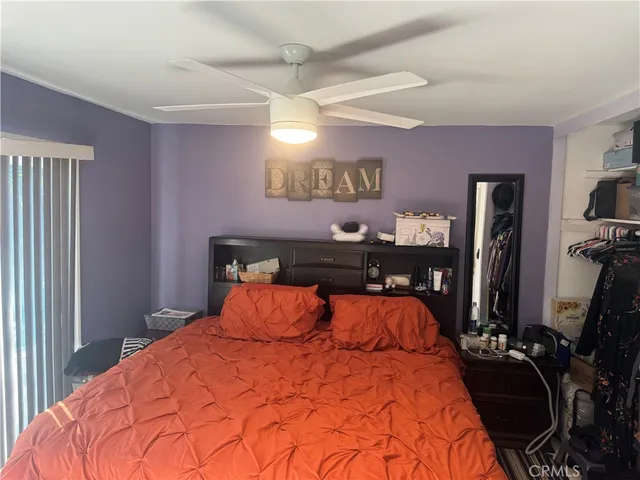 a bed sitting in a bedroom next to a window