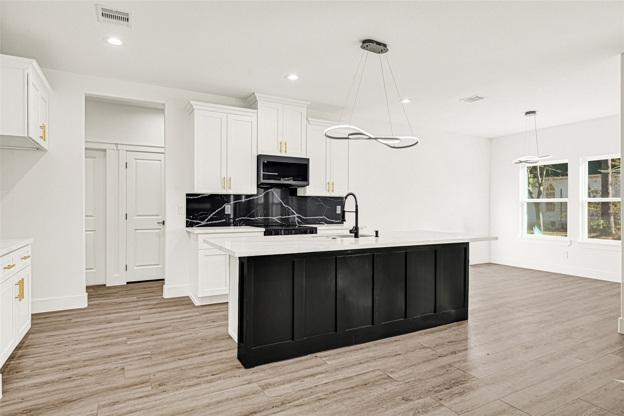 105 Bledsoe Street Prairie View, TX 77446 - Photo 12 of 35 Large kitchen island with decorative chandelier