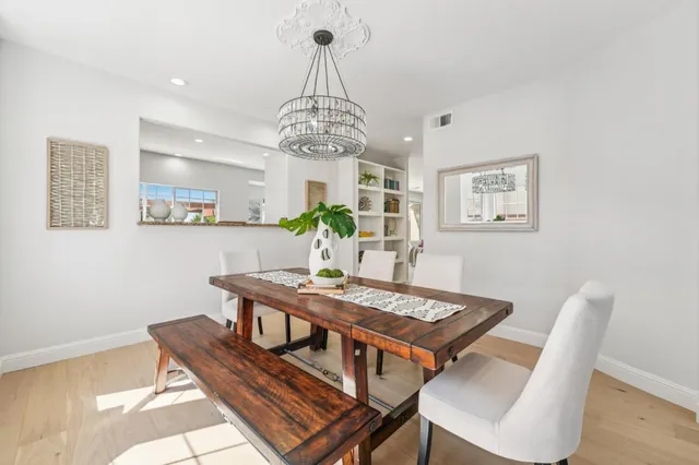 a living room with furniture a fireplace and a ceiling fan