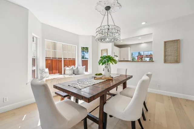 a living room with furniture a fireplace and a large window