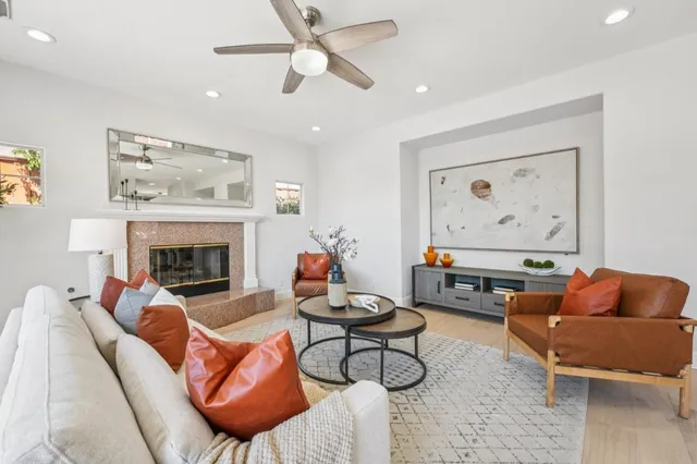 a kitchen with stainless steel appliances kitchen island granite countertop a refrigerator a stove a sink and white cabinets