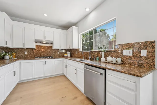 a bathroom with a double vanity sink a mirror and a shower