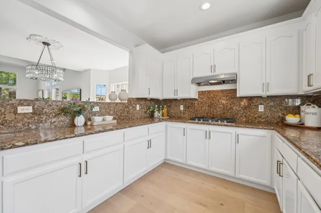 a bathroom with a sink vanity granite and a mirror