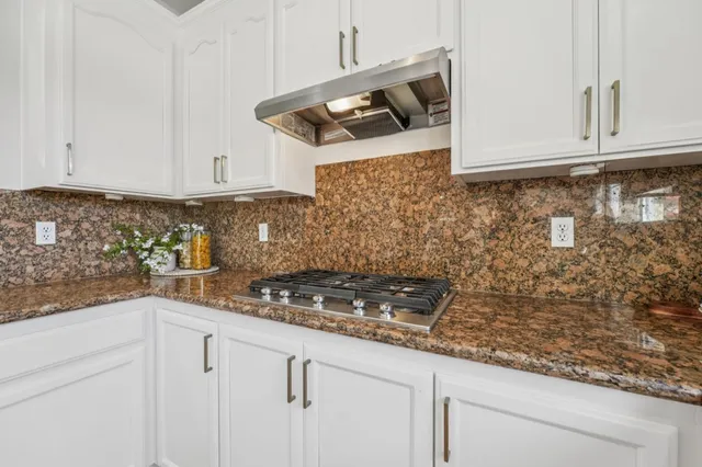a bathroom with double vanity sinks a vanity a lamp and a mirror