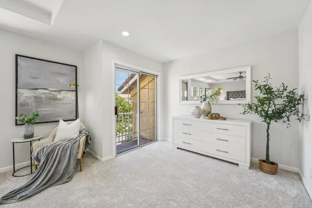 a front view of a house with a yard and a tree