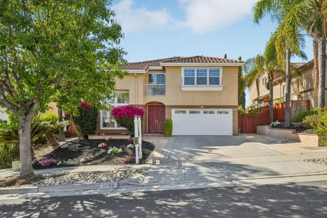 a living room with furniture and large windows
