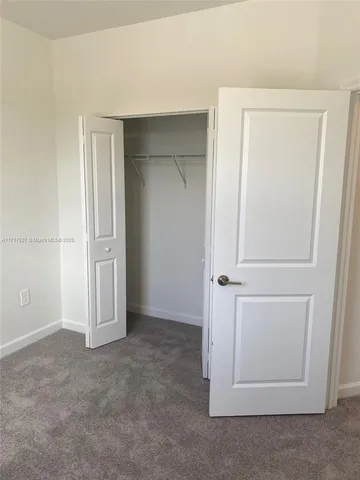 an empty room with closet area