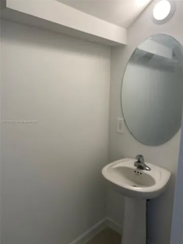 a bathroom with a sink and mirror