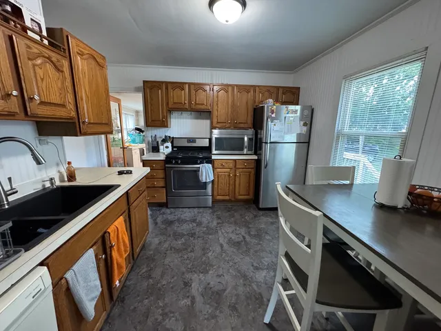 a kitchen with refrigerator cabinets and a sink
