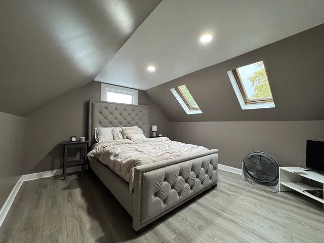 a bedroom with a bed and a night stand