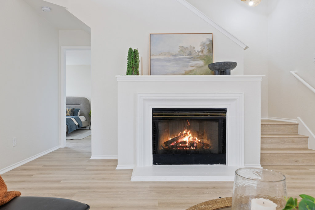 1305 Tudor House Road Pflugerville, TX 78660 - Photo 12 of 40 The fireplace anchors the living area, adding warmth and character and creating a natural gathering point for everyday living.